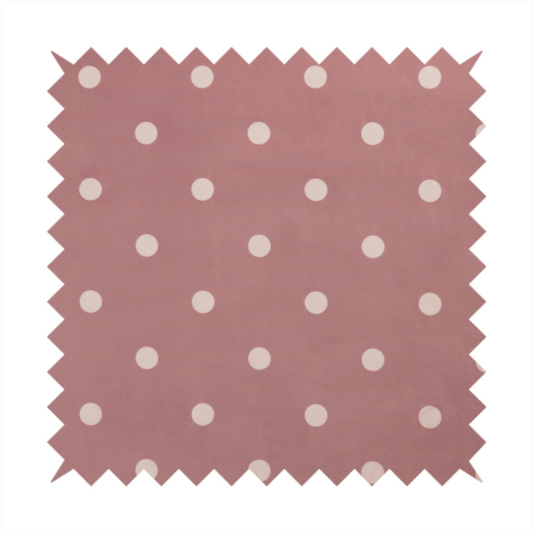 A dusty rose or mauve fabric pattern featuring evenly spaced off-white polka dots arranged in horizontal and vertical rows.