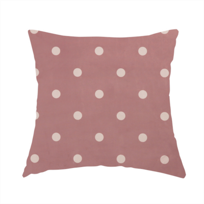 The fabric used to create this handmade cushion is a dusty rose or mauve fabric pattern featuring evenly spaced off-white polka dots arranged in horizontal and vertical rows.