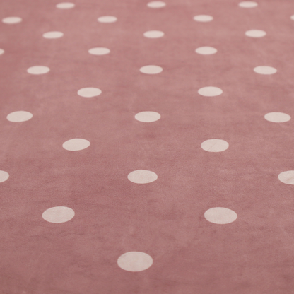 A dusty rose or mauve fabric pattern featuring evenly spaced off-white polka dots arranged in horizontal and vertical rows.