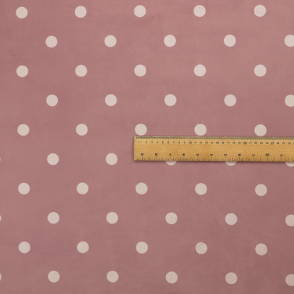 A dusty rose or mauve fabric pattern featuring evenly spaced off-white polka dots arranged in horizontal and vertical rows.