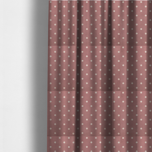 The fabric used to create these made-to-measure curtains is a dusty rose or mauve fabric pattern featuring evenly spaced off-white polka dots arranged in horizontal and vertical rows.