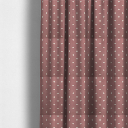 The fabric used to create these made-to-measure curtains is a dusty rose or mauve fabric pattern featuring evenly spaced off-white polka dots arranged in horizontal and vertical rows.