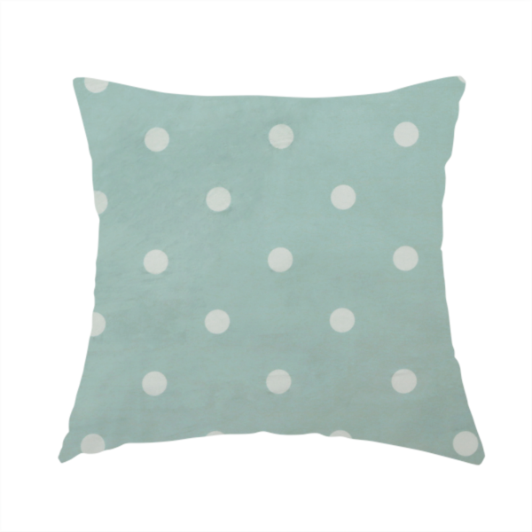 The fabric used to create this handmade cushion is a sage green or pale teal fabric pattern featuring evenly spaced white polka dots arranged in horizontal and vertical rows.