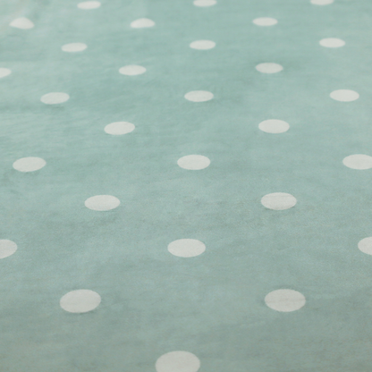 A sage green or pale teal fabric pattern featuring evenly spaced white polka dots arranged in horizontal and vertical rows.