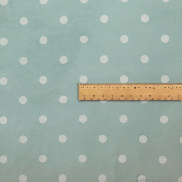 A sage green or pale teal fabric pattern featuring evenly spaced white polka dots arranged in horizontal and vertical rows.