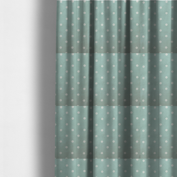 The fabric used to create these made-to-measure curtains is a sage green or pale teal fabric pattern featuring evenly spaced white polka dots arranged in horizontal and vertical rows.