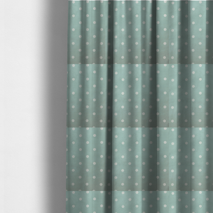 The fabric used to create these made-to-measure curtains is a sage green or pale teal fabric pattern featuring evenly spaced white polka dots arranged in horizontal and vertical rows.
