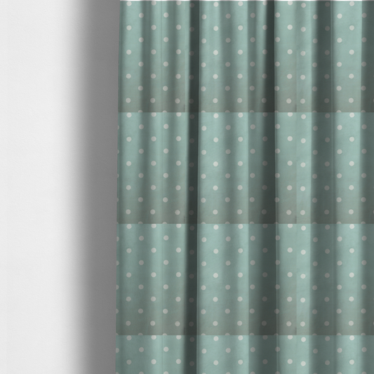 The fabric used to create these made-to-measure curtains is a sage green or pale teal fabric pattern featuring evenly spaced white polka dots arranged in horizontal and vertical rows.
