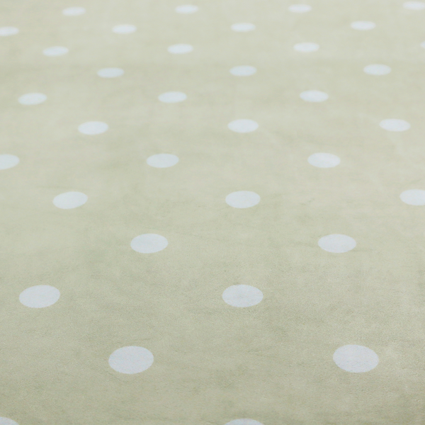 A cream or beige fabric pattern featuring evenly spaced white polka dots arranged in horizontal and vertical rows.