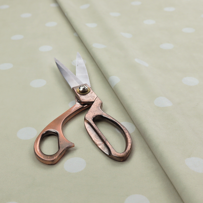 A cream or beige fabric pattern featuring evenly spaced white polka dots arranged in horizontal and vertical rows.