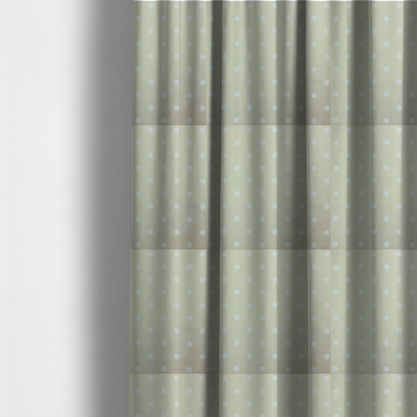 The fabric used to create these made-to-measure curtains is a cream or beige fabric pattern featuring evenly spaced white polka dots arranged in horizontal and vertical rows.