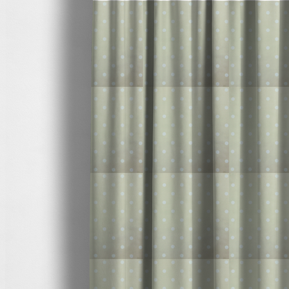 The fabric used to create these made-to-measure curtains is a cream or beige fabric pattern featuring evenly spaced white polka dots arranged in horizontal and vertical rows.