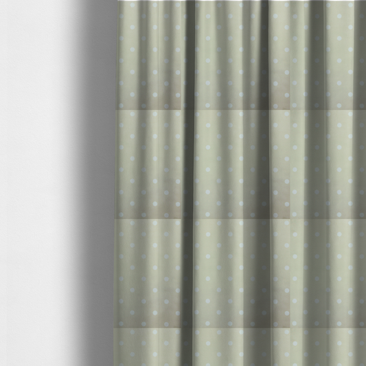 The fabric used to create these made-to-measure curtains is a cream or beige fabric pattern featuring evenly spaced white polka dots arranged in horizontal and vertical rows.