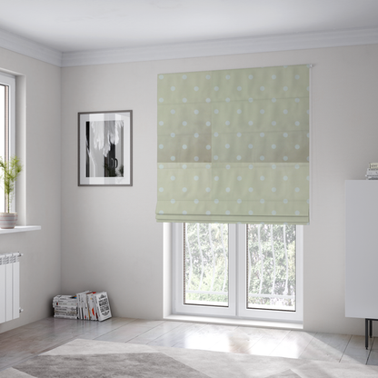 The fabric used to create these Roman blinds is a cream or beige fabric pattern featuring evenly spaced white polka dots arranged in horizontal and vertical rows.