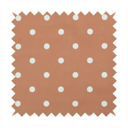 A terracotta or warm brown fabric pattern featuring evenly spaced white polka dots arranged in horizontal and vertical rows.