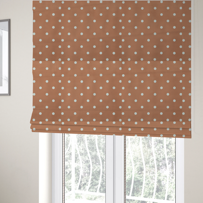 The fabric used to create these Roman blinds is a terracotta or warm brown fabric pattern featuring evenly spaced white polka dots arranged in horizontal and vertical rows.