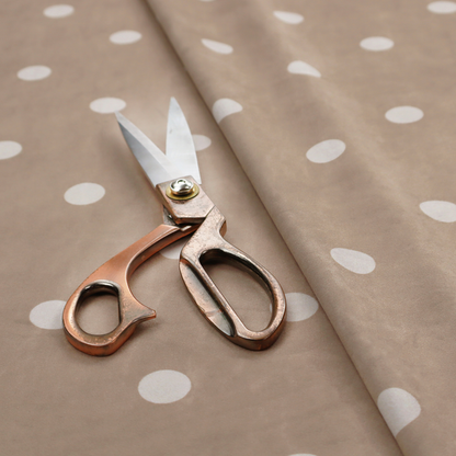 A taupe or warm grey-brown fabric pattern featuring evenly spaced white polka dots arranged in horizontal and vertical rows.