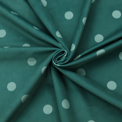 A dark teal or blue-green fabric pattern featuring evenly spaced pale green or off-white polka dots arranged in horizontal and vertical rows.