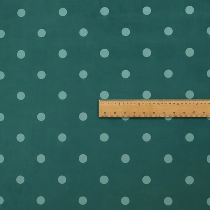 A dark teal or blue-green fabric pattern featuring evenly spaced pale green or off-white polka dots arranged in horizontal and vertical rows.