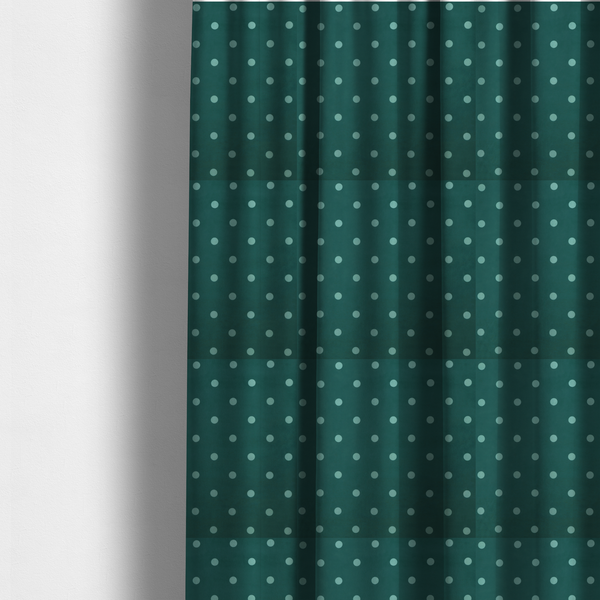 The fabric used to create these made-to-measure curtains is a dark teal or blue-green fabric pattern featuring evenly spaced pale green or off-white polka dots arranged in horizontal and vertical rows.