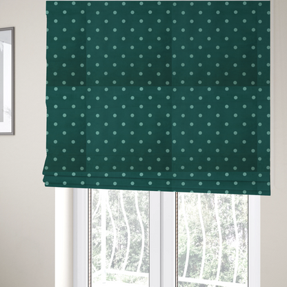The fabric used to create these Roman blinds is a dark teal or blue-green fabric pattern featuring evenly spaced pale green or off-white polka dots arranged in horizontal and vertical rows.