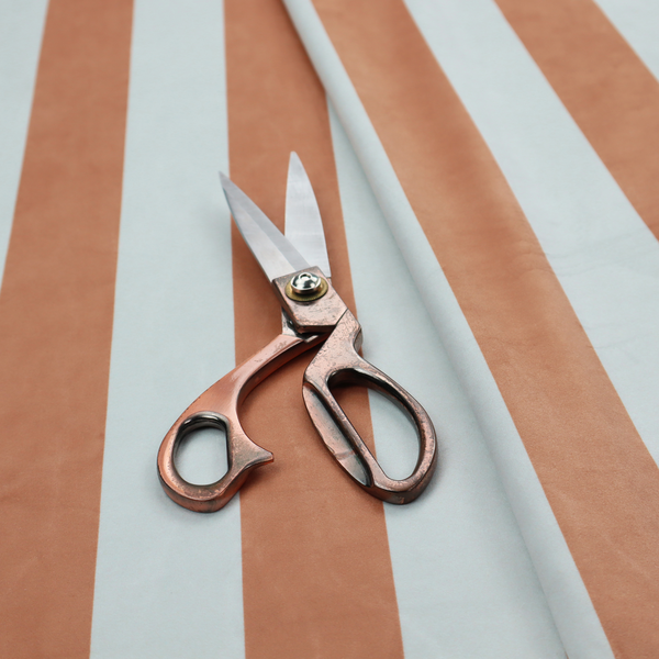 A vertically striped fabric pattern featuring alternating bands of terracotta or warm brown and white.