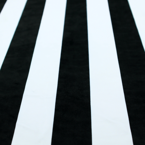 A vertically striped fabric pattern featuring alternating bands of black and white.