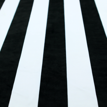 A vertically striped fabric pattern featuring alternating bands of black and white.