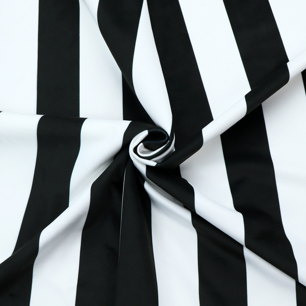 A vertically striped fabric pattern featuring alternating bands of black and white.
