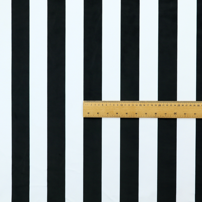 A vertically striped fabric pattern featuring alternating bands of black and white.