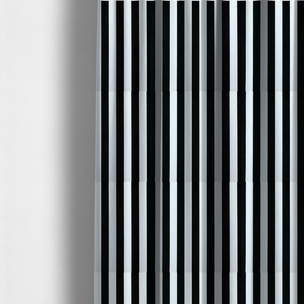The fabric used to create these made-to-measure curtains is a vertically striped fabric pattern featuring alternating bands of black and white.