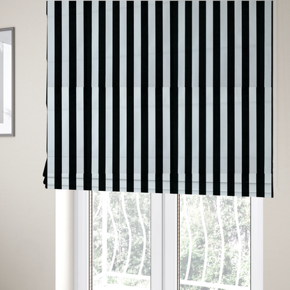 The fabric used to create these Roman blinds is a vertically striped fabric pattern featuring alternating bands of black and white.