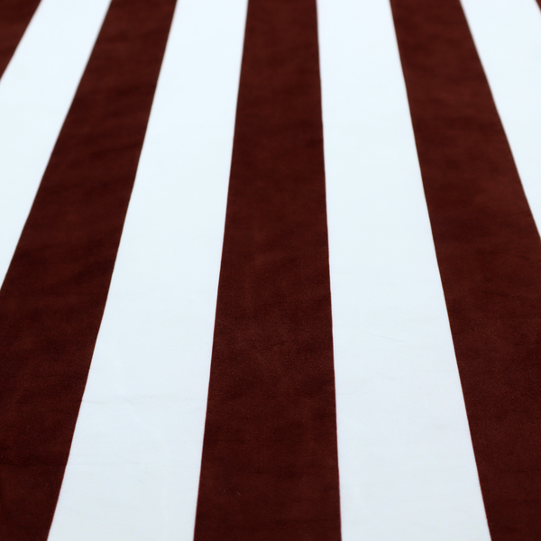 A vertically striped fabric pattern featuring alternating bands of dark brown and white.