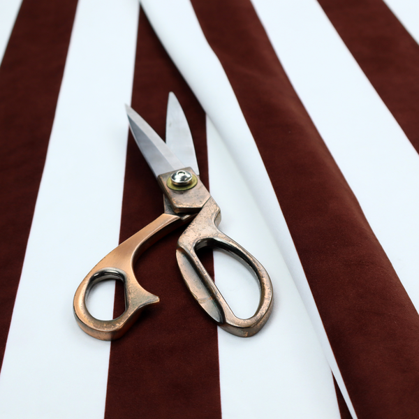 A vertically striped fabric pattern featuring alternating bands of dark brown and white.