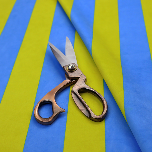 A vertically striped fabric pattern featuring alternating bands of bright yellow and blue.