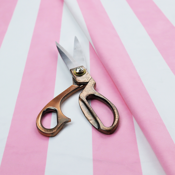 A vertically striped fabric pattern featuring alternating bands of pink and white.