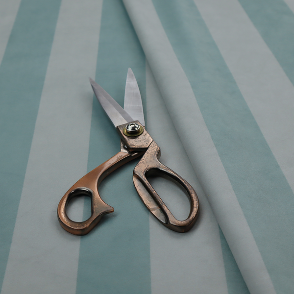 A vertically striped fabric pattern featuring alternating bands of soft blue-green or teal and white.