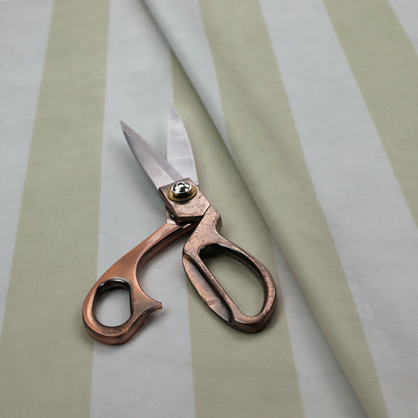 A vertically striped fabric pattern featuring alternating bands of soft sage green or cream and white.