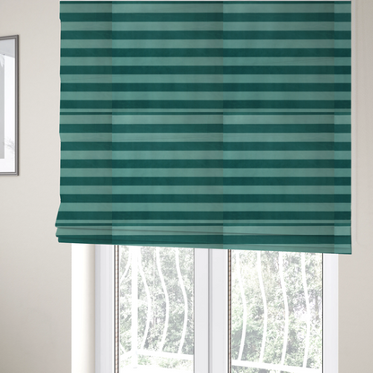 The fabric used to create these Roman blinds is a horizontally striped fabric pattern featuring alternating bands of dark teal and a lighter mint green or blue-green tone.
