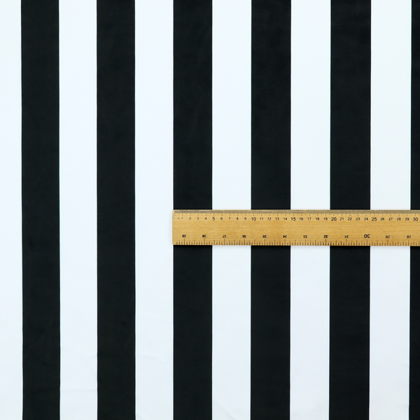 A horizontally striped fabric pattern featuring alternating bands of dark black and white.   