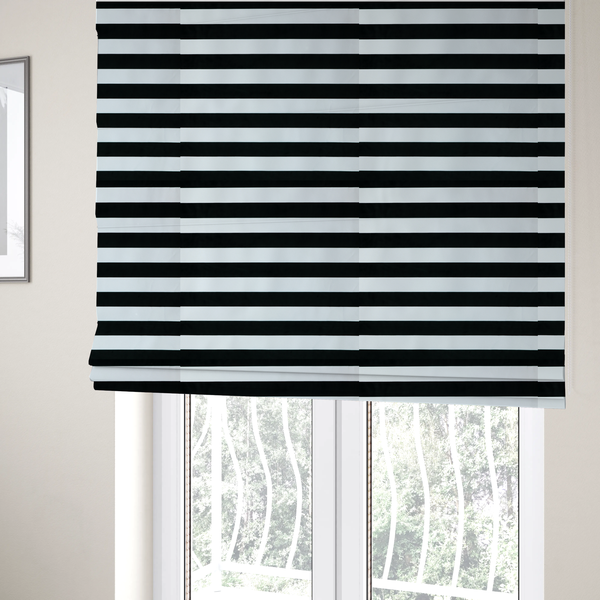 The fabric used to create these Roman blinds is a horizontally striped fabric pattern featuring alternating bands of dark black and white.   