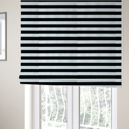 The fabric used to create these Roman blinds is a horizontally striped fabric pattern featuring alternating bands of dark black and white.   