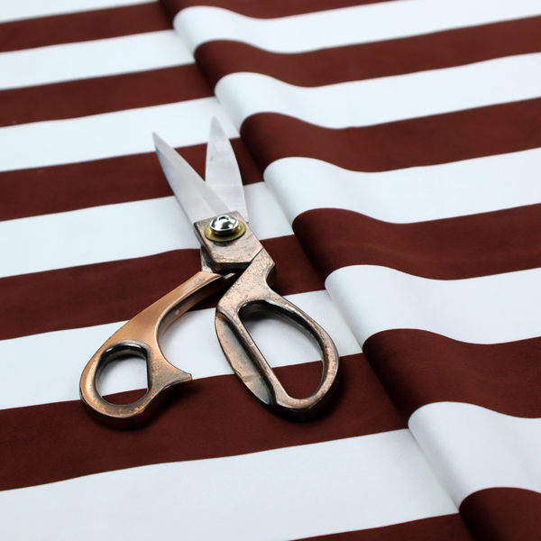 A horizontally striped fabric pattern featuring alternating bands of dark brown and white.