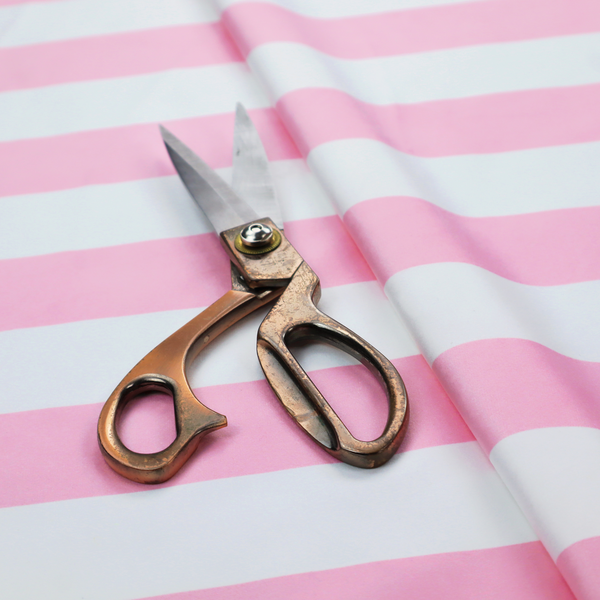 A horizontally striped fabric pattern featuring alternating bands of soft pink and white.