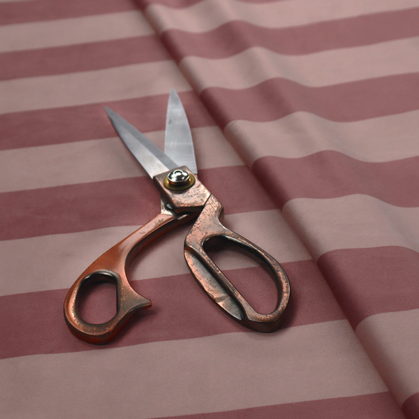 A horizontally striped fabric pattern featuring alternating bands of muted dusty pink and a lighter mauve or rose tone.