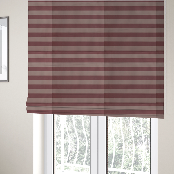 The fabric used to create these Roman blinds is a horizontally striped fabric pattern featuring alternating bands of muted dusty pink and a lighter mauve or rose tone.