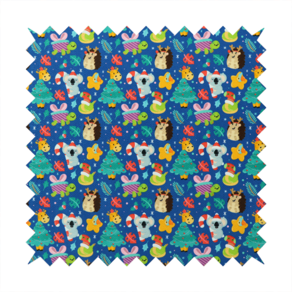 A repeating festive Christmas print on a royal blue background featuring cute cartoon holiday characters, including koalas wearing Santa hats, hedgehogs with antlers, giraffes, Christmas trees, wrapped presents, and stars.   