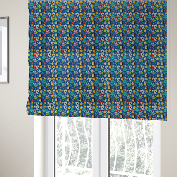 The fabric used to create these Roman blinds is a repeating festive Christmas print on a royal blue background featuring cute cartoon holiday characters, including koalas wearing Santa hats, hedgehogs with antlers, giraffes, Christmas trees, wrapped presents, and stars.   