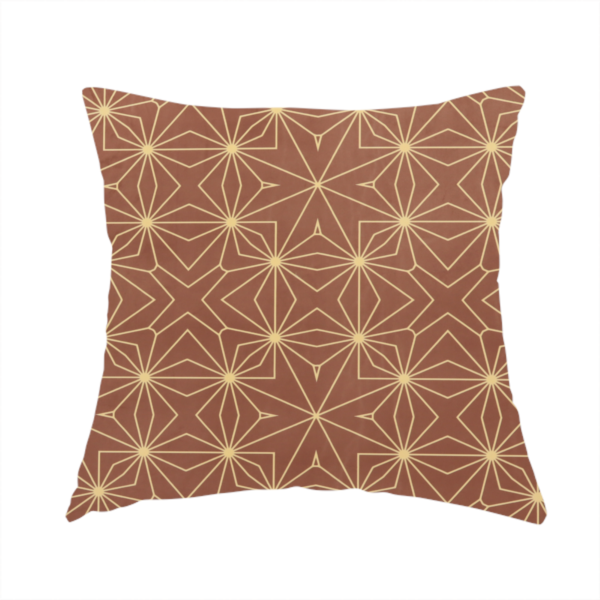 The fabric used to create this handmade cushion is a geometric upholstery fabric featuring an intricate, repeating starburst and lattice pattern in cream lines on a warm terracotta brown background.   