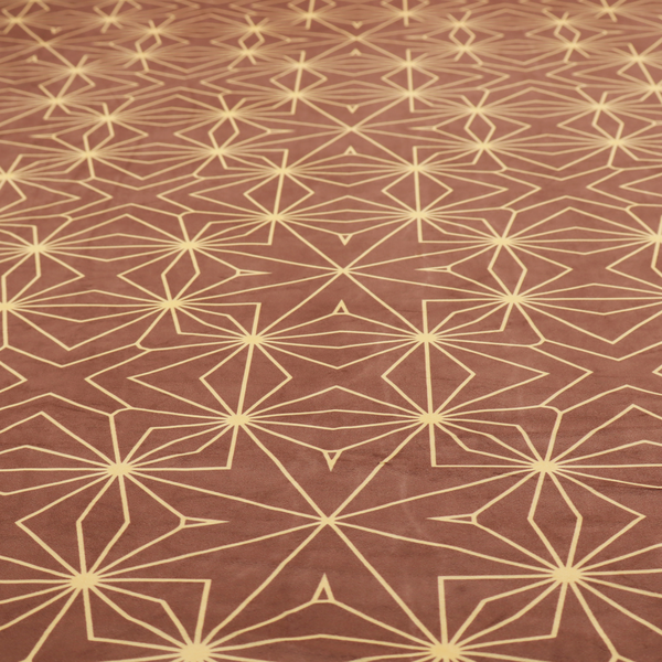 A geometric upholstery fabric featuring an intricate, repeating starburst and lattice pattern in cream lines on a warm terracotta brown background.   